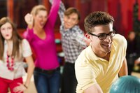A corporate bowling party allows employees to socialize outside of the office.
