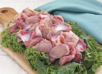 Plate of raw chicken gizzards.