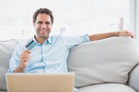 Man holding up credit card