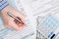 A man is filling out tax forms.