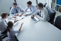 Five business people having a meeting in an office