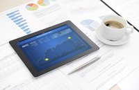 A financial analysis is on a tablet on a desk.