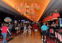People walking through the interior of a casino.