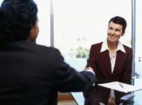 Professional woman shaking a man's hand,