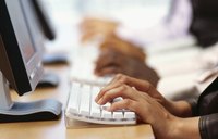 Close-up of hands typing on keyboard.