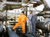 Men are standing in a power plant.