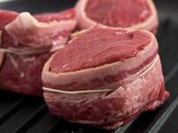 Wrapping medallions with bacon before cooking them adds flavor and moisture to the meat.