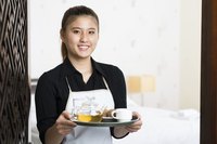 Young waitress holding a tray.
