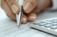 Close up of pen, data and calculator