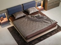 An overhead view of a contemporary bed with a fitted sheet covering the box spring.