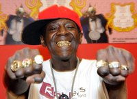 Rap artist Flavour flav smiles to show his grillz.