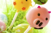 Make simple piggy cake pops with pink candy melts and brown piping.
