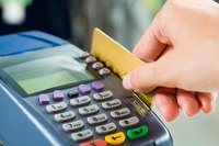 Close-up of credit card being swiped