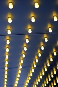 Christmas light strands pushed through the back of a sign resemble a light-up marquee.