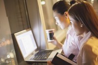 A young woman is on the computer.