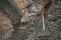 Concrete being poured into sidewalk construction site