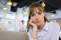 A depressed woman sitting in a modern office