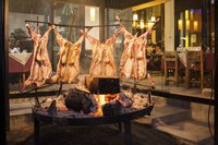 Goats roasting over a large BBQ