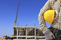 Construction worker standing in front of construction site