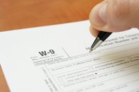 Man about to complete a W-9 form.