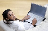 Young woman using laptop computer from home.