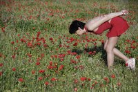 Woman in a field wearing a drop waist dress.