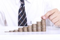 Close-up of man stacking coins