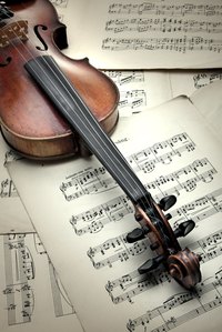 Decoupage a feature wall or canvas with sheet music as a backdrop.
