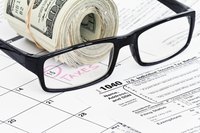 A tax form with refund money sitting on it.