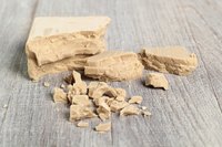 Fresh yeast is sold in a moist, crumbly block or "cake."