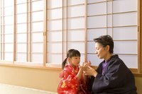 Grandmother and grandchild sitting in front of shoji screen