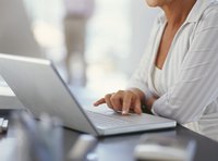 A businesswoman is typing on her laptop.