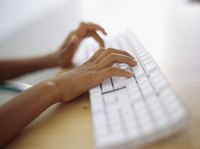 Hands typing on a computer keyboard