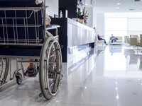 A close-up of a disabled person in a hospital corridor.