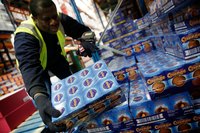A worker handling product in a distribution center.