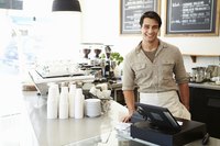 Portrait of a coffee shop owner behind the counter.