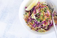 Use a grater to shred carrots into pieces of a size similar to the grated cabbage.
