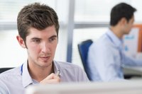Close-up of young man looking at computer screen