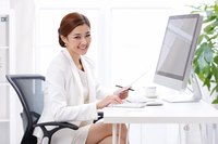 Businesswoman working on budget at desk.