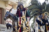 Nativity statues grace a float in the street during a parade.