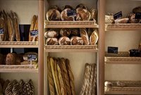 A wall of freshly baked breads in a bakery.