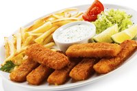 Fish sticks, fries, tartar sauce and lemon wedges make a traditional dish.