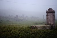 Mist covers the grave stones in an old cemetary.