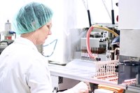 Woman working at pharmaceutical company, helping package products