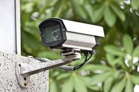 Close-up of a CCTV camera mounted on the side of a building