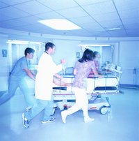 Medical team pushing a patient on a gurney