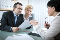 A lawyer meeting with clients in her office