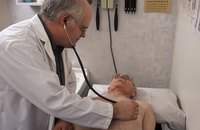 Doctor examining senior patient