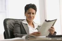 A business woman is reading a published journal.