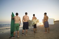 Rear view of young surfer men.